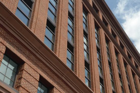 77H's exteriors mimic the façades and brick detail of nearby buildings, particularly that of the adjacent historical Government Printing Office. 