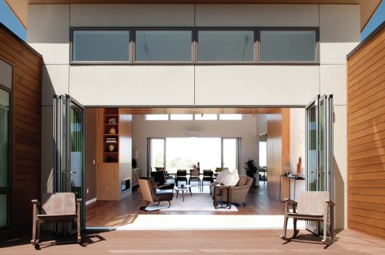 Folding glass walls open the cube-shaped central living area to the outdoors. 