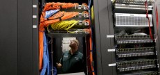 POMPANO BEACH, FL - FEBRUARY 13: Warren Myers, a headend manager, stands among the cables and routers at a Comcast distribution center where the Comcast regional video, high speed data and voice are piped out to customers on February 13, 2014 in Pompano Beach, Florida.  Today, Comcast announced a $45-billion offer for Time Warner Cable.  (Photo by Joe Raedle/Getty Images)