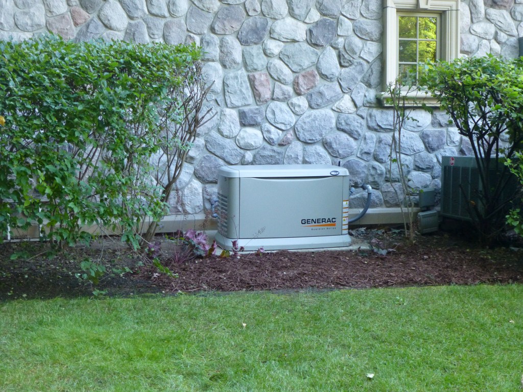 A standby home generator from the Generac Guardian series installed at a lakeside home.
