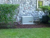 A standby home generator from the Generac Guardian series installed at a lakeside home.