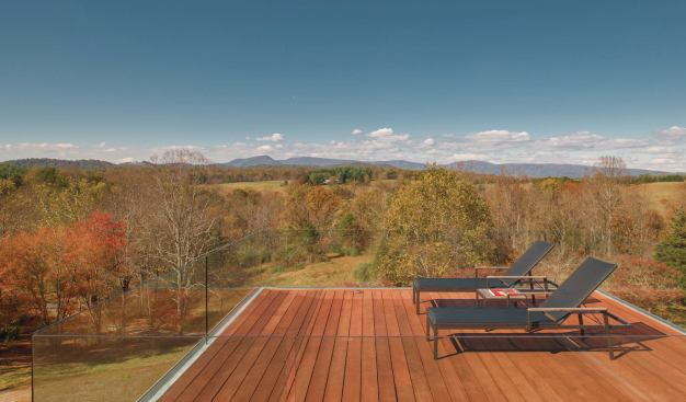 Glass railings enclose the roof deck.