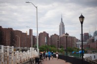 The Empire State building stands in the skyline past Stuyvesant Town-Peter Cooper Village, Manhattan's largest apartment complex, in New York, U.S., on Sunday, May 18, 2014. CWCapital Asset Management LLC, the loan servicer that has been in charge of Stuyvesant Town-Peter Cooper Village since its owners defaulted on a $3 billion mortgage in 2010, is holding a foreclosure sale on June 13 for $300 million of junior loans. While CWCapital holds that debt and is poised to officially take over the property at the auction, other bidders may come with their own plans to pay off bondholders. Photographer: Michael Nagle/Bloomberg