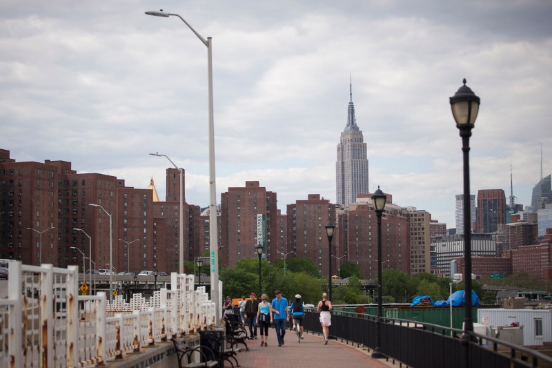 The Empire State building stands in the skyline past Stuyvesant Town-Peter Cooper Village, Manhattan's largest apartment complex, in New York, U.S., on Sunday, May 18, 2014. CWCapital Asset Management LLC, the loan servicer that has been in charge of Stuyvesant Town-Peter Cooper Village since its owners defaulted on a $3 billion mortgage in 2010, is holding a foreclosure sale on June 13 for $300 million of junior loans. While CWCapital holds that debt and is poised to officially take over the property at the auction, other bidders may come with their own plans to pay off bondholders. Photographer: Michael Nagle/Bloomberg
