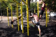 NEW YORK, NY - SEPTEMBER 02:  Men excercise on bars in Tompkin Square Park on September 2, 2014 in New York City. After an unusually cool summer, temperatures are supposed to hit the high 80s this week.  (Photo by Andrew Burton/Getty Images)
