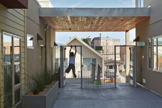 Pops of color, industrial materials, and artwork help the building harmonize with neighboring buildings. 