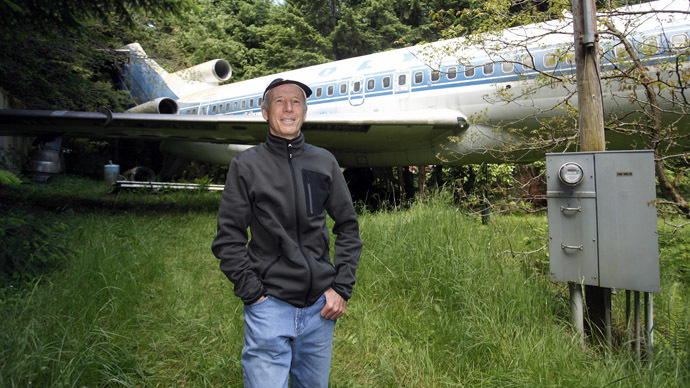 Bruce Campbell stands near his Boeing 727 home in the woods outside the suburbs of Portland, Oregon May 21, 2014. In 1999, the former electrical engineer had a vision: To save retired jetliners from becoming scrap metal by reusing them. Campbell, 64, is one of a small number of people worldwide who have transformed retired aircraft into a living space or other creative project, although a spokesman for the Aircraft Fleet Recycling Association was unable to say precisely how many planes are re-used this way. Picture taken May 21.  REUTERS/Steve Dipaola  (UNITED STATES - Tags: SOCIETY TRANSPORT REAL ESTATE) - RTR3SP8I