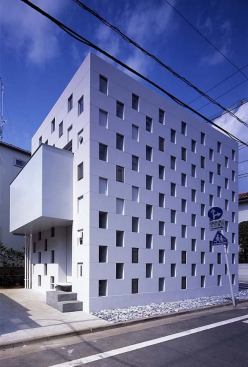 The boxes are stacked in such a way as to provide seismic resistance as well as load-bearing support.