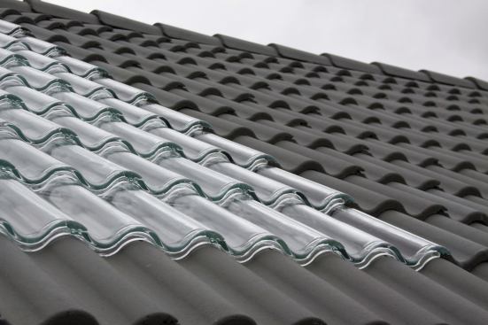 The glass tiles are installed just like ordinary clay roof tiles and can be used in lieu of or on top of their traditional counterparts. 