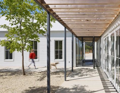 Half-circle gutters soften the austerity of the house and reference