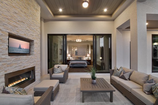 The master suite looks out on a solana and hearth, and the waterway beyond.