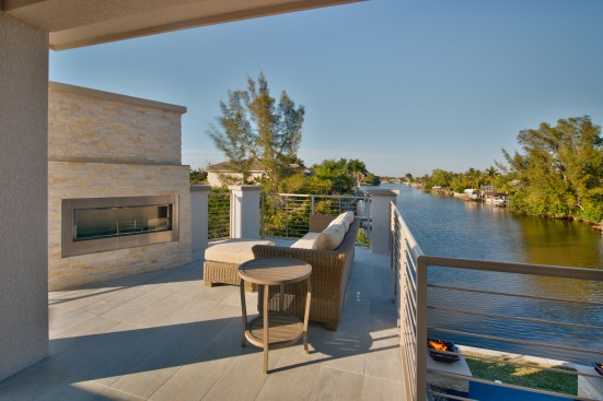 Upstairs are two bedrooms, two baths, and a shared deck with an outdoor fireplace.