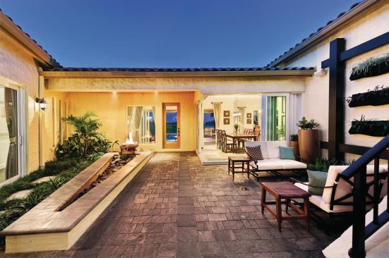 This courtyard does double-duty, serving as both entryway and sitting area. It flows gracefully into the kitchen and dining area, making it an ideal spot to sit and relax before or after dinner. Here, fire meets water: A glowing flame at the far end of the fountain helps animate and illuminate the space at night, giving a warm welcome.