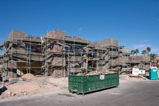 STANDING SILENT: The New American Home 2010 remains largely unchanged since November as the builder awaits a $1.8 million bridge loan to finish it. A rendering (above) provides an accurate glimpse of what the desert contemporary custom home will look like when (and if) it is finished.