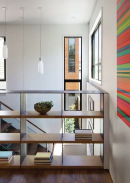 Making storage part of the architecture like with this railing cum open bookshelf allows the 1,500-square-foot houses to live larger and light can flow through unabated. 