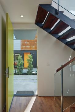 In a city with an acute housing shortage, and where the zoning code encourages maximizing density, the architects were allowed the minimum 25-foot rear yard to be located between the two detached structures. 