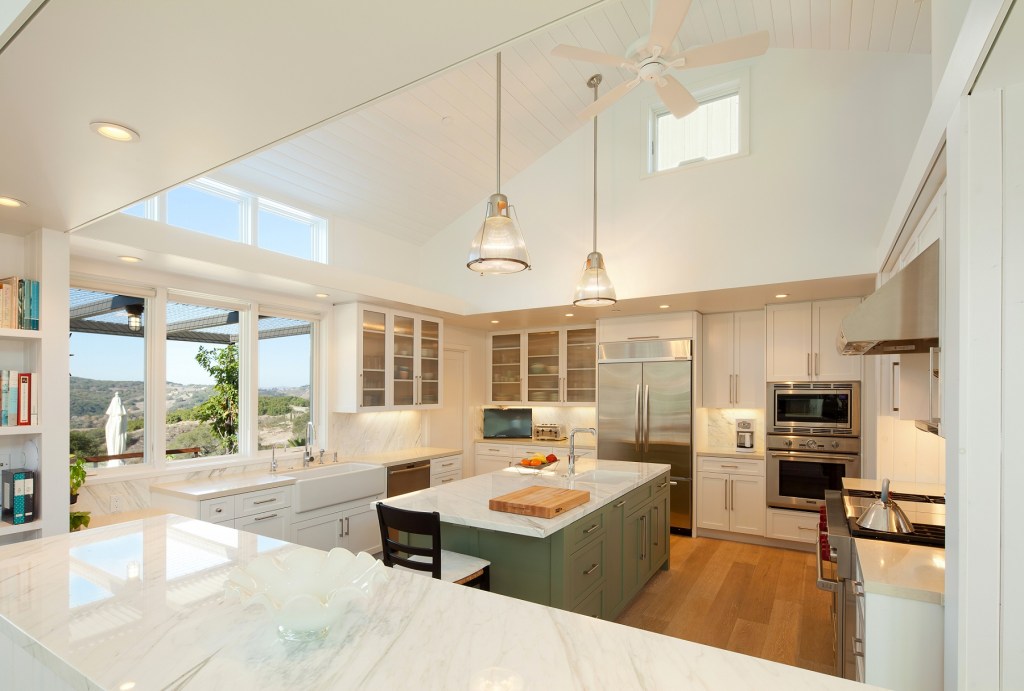 This all-white kitchen keeps a large room simple with clean,
modern lines. Frosted glass cabinet doors and marble countertops add dimension
to the white color scheme, while skylights in the angled ceiling provide a
flood of natural light that opens up the space. Project: Arroyo Grande Modern
Farmhouse by Gast Architects