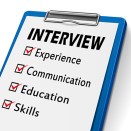 interview clipboard with check boxes marked for experience, communication, education and skills