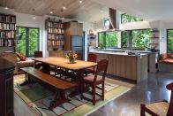 Simplicity Rules In the Garden Library project (above), Nettleton combined dining, kitchen, and library functions into a compact, efficiently detailed space. In the Minnesota Valley Home (below), south-facing sliding doors supply views, solar gain, and natural ventilation. The vaulted roof and polished concrete floor unite the house’s public and private zones.