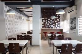 Situated in an old warehouse, the café uses salvaged materials and furniture to minimize costs