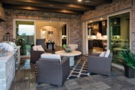 A rendering of a kitchen and courtyard at Bridge View at Chapel Creek by Darling Homes.