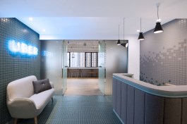 Referencing the local urban life, the reception introduces vibrantly coloured tiled walls and floors