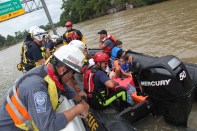 Members of FEMA's Urban Search and Rescue Nebraska Task Force One (NE-TF1) rescue a family from a neighborhood impacted by flooding from Hurricane Harvey