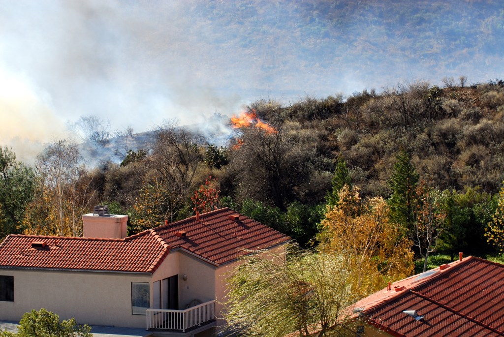 brushfire approaching a home