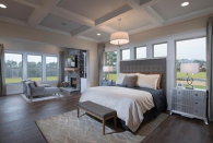 This bedroom incorporates loads of natural light, a soft headboard and no footboard for the best of aging in place.