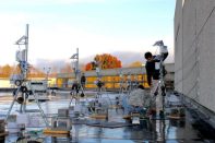 Architecture student researchers set up equipment on the roof of the small animal hospital at the Virginia-Maryland College of Veterinary Medicine.