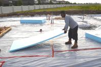 Sheets of insulation are installed below the slab for the reNEWable Living Home.