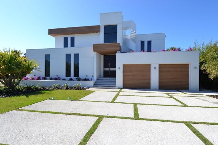 Materiality makes otherwise standard façade elements pop in this contemporary custom home. TruGrain® façade and siding products provide the look and warmth of hardwood and the durability of a hybrid.