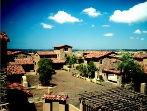 THE ANTI-SUBURB: “The Sentinels is not a suburban solution,” stated the builder of this 80-unit hillside community (above) in San Diego, the 2002 Project of the Year. The plan sacks the cul-de-sac concept in favor of eight-unit clusters that set detached homes 10 feet apart to minimize land use; preserve views, lifestyle, and a high level of privacy; and create the feel of a family hacienda. Rustic materials and a range of rooflines and floor plans helps create an ample and attractive motor court in the center of each cluster.