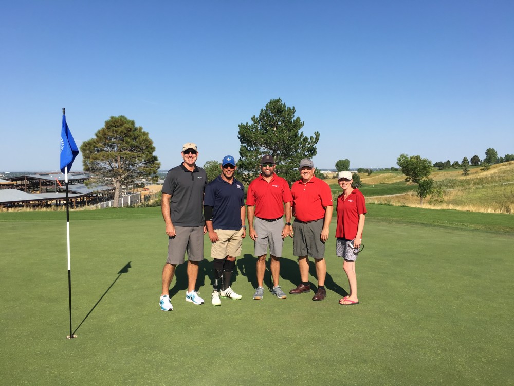 Veteran Nick Morris, second from left, playing golf with HomeSphere staff and partners at the company’s annual Partner Summit. Morris is the recipient of a HFOT home; the golf tournament raised $2300 for the cause.