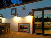 The outdoor deck area features the NanaWall SL60 system that fully retracts to open the space between the living room and patio.