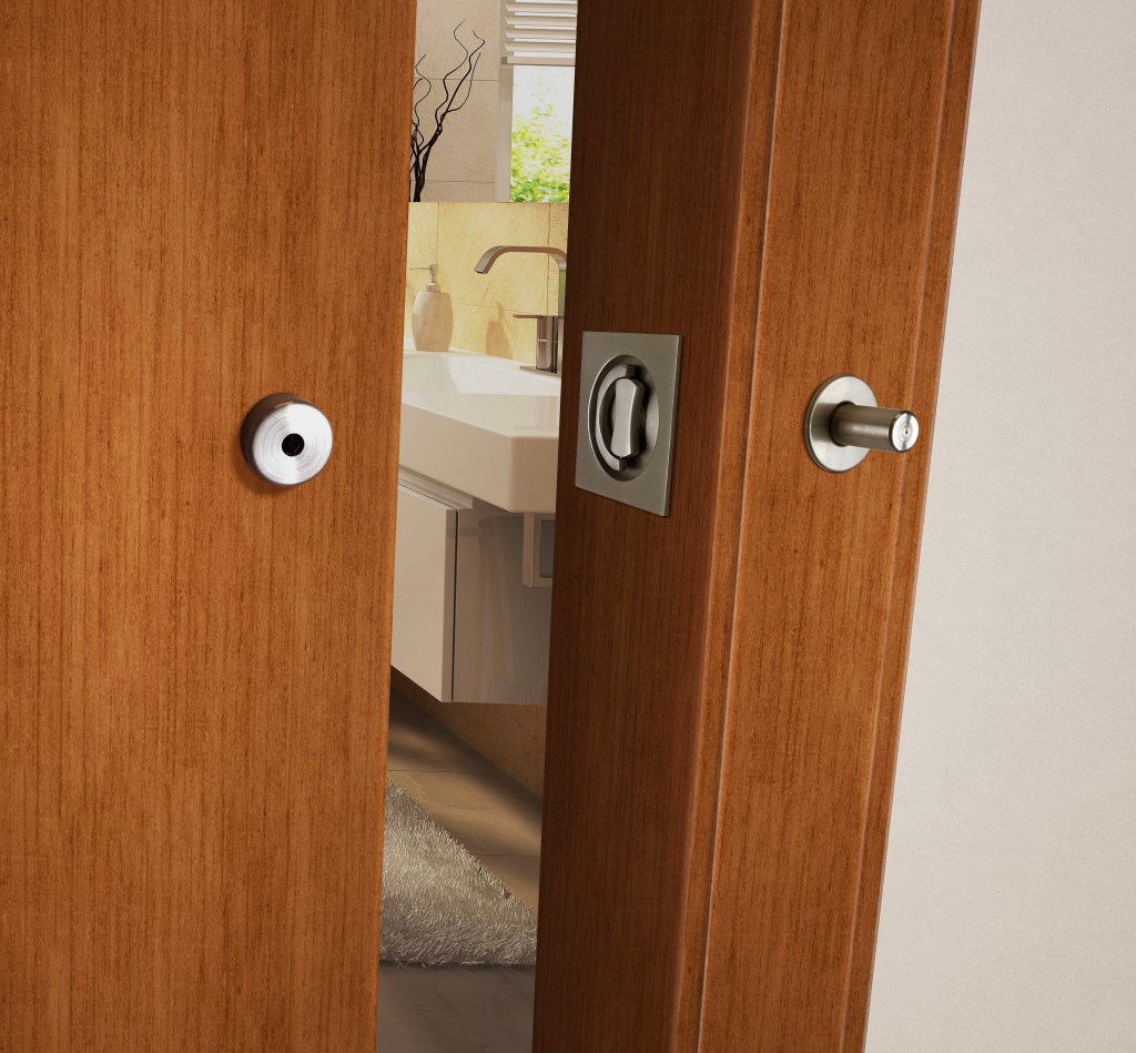 The INOX Privacy Barn Door Lock, shown here with a Luna flush trim.