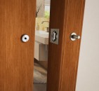 The INOX Privacy Barn Door Lock, shown here with a Luna flush trim.