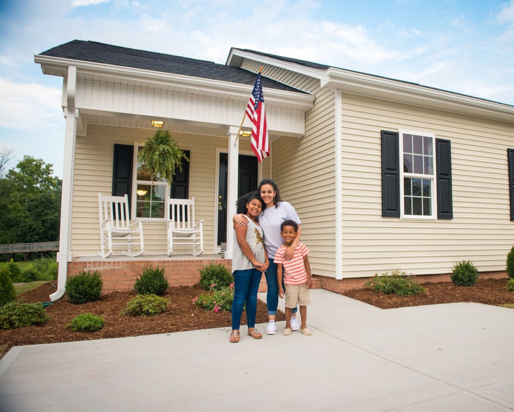 New homeowners in Raleigh, NC, happy to receive their new house keys. One of the nearly 500 homes built or remodeled through product donations by Ply Gem as part of the company’s Home for Good project.