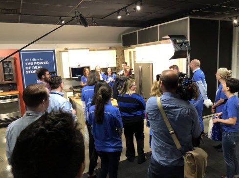 Ally Phillips (center) hugs Kevin Nolan, President and CEO of GE Appliances, after learning that she has been chosen as the Great American Grandma.