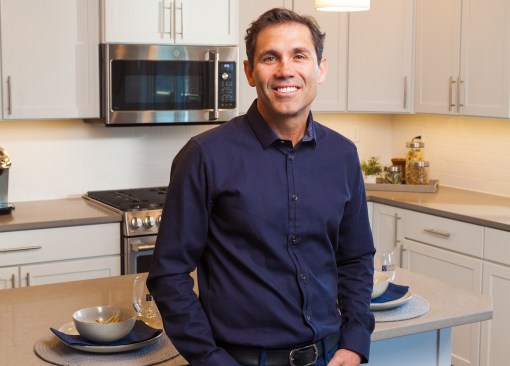 Hayden Watson relaxes in the kitchen of one of his firm's model homes.