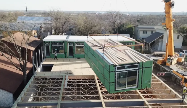 A crane lifts a unit into place on the 24,000-square-foot mixed use MLK project just outside of downtown Austin.