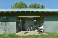 Buster Ward sits outside his West Alabama home, which was designed and financed as part of Rural Studio’s Front Porch Initiative.