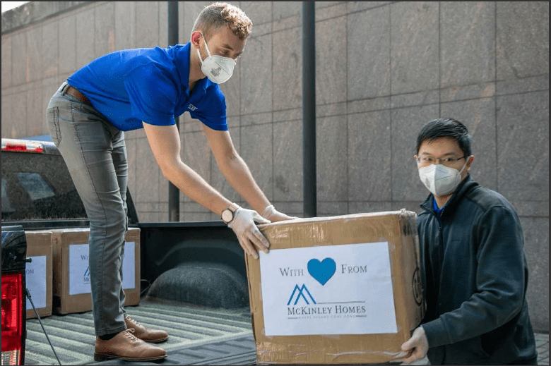 McKinley Homes team members load up medical masks.