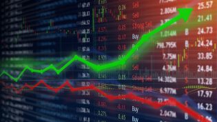 Investing and stock market concept gain and profits with faded candlestick charts.