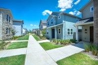 The pedestrian and pet-friendly community includes walkways to each front door with private yards on the side.