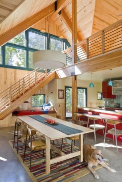 The double-height, sunny great room includes a dining area and a second floor that's open to the rest of the house. 