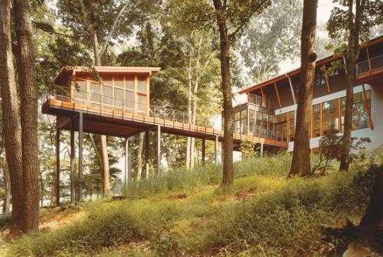 Both the main house and the separate porch take in abundant views of their leafy surroundings.