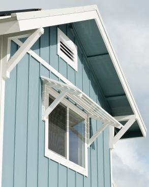 Deep overhangs and prefinished aluminum awnings shade interiors from Hawaii’s hot summer sun.