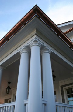 At the front entryway, Tuscan columns are ganged in threes.