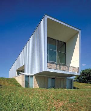 An open floor plan, as well as translucent elements like crumpled mesh railings and Lumasitebacked bookshelves, allow light to filter all the way through the building.